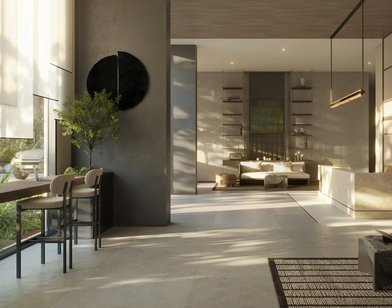 Residents’ lobby with a sculptural olive tree and stone walls