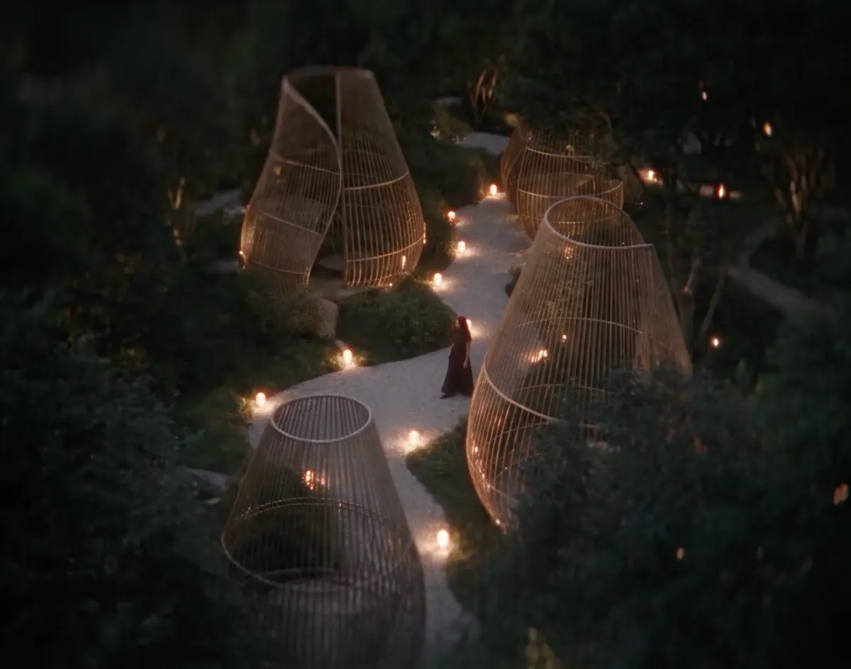 The Pod Garden at night, lit by lanterns along a winding path
